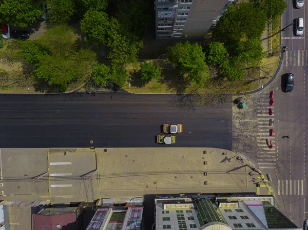 Aerial top down view of asphalting construction works with commercial repair equipment road roller compactor machine. Contrast between new and old road surface. — Stock Photo, Image