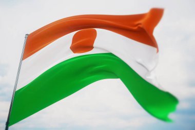 Dünyanın bayraklarını sallayan Nijer bayrağı. Sığ bir alan derinliği ve seçici bir odak noktasıyla vurulmuş. 3B illüstrasyon.