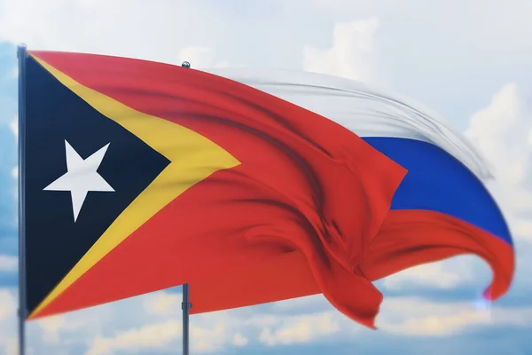 Ondeando bandera rusa y bandera de Timor Oriental. Vista de primer plano, ilustración 3D. —  Fotos de Stock