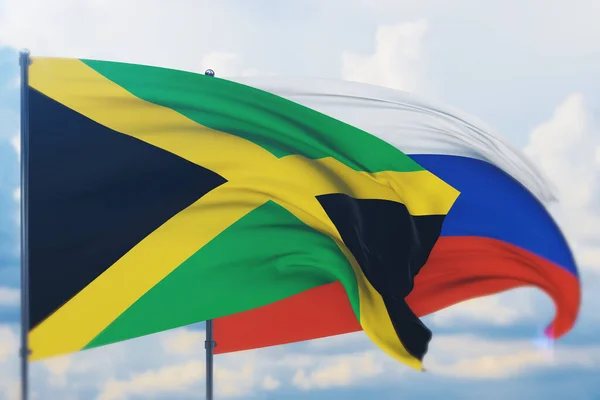 Sventola bandiera russa e bandiera della Giamaica. Vista da vicino, illustrazione 3D. — Foto Stock