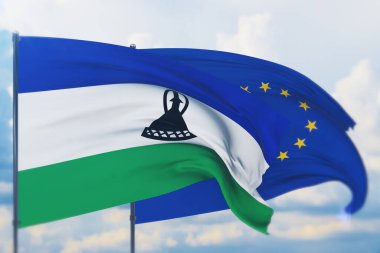 Avrupa Birliği bayrağı ve Lesotho bayrağı sallıyordu. Yakın görünüm, 3 boyutlu illüstrasyon.