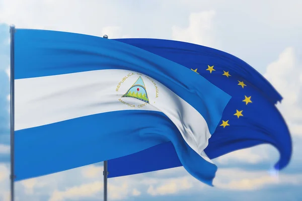 Flagge der Europäischen Union und Flagge Nicaraguas schwenkend. Nahaufnahme, 3D-Illustration. — Stockfoto