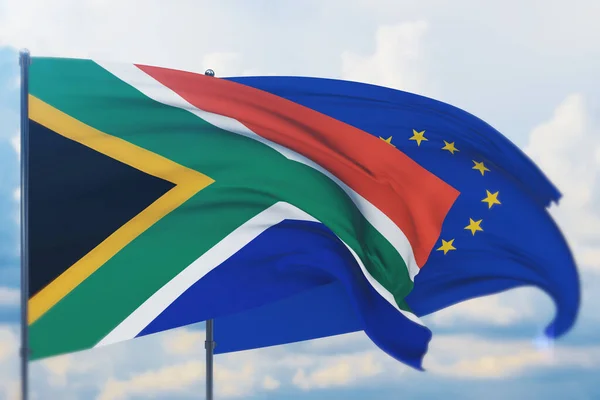 Acenando bandeira da União Europeia e bandeira da África do Sul. Vista de perto, ilustração 3D. — Fotografia de Stock