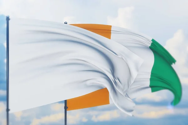 Білий прапор на флагштоку розмахує вітром і прапором Кот-Івуару. Closeup view, 3D illustration. — стокове фото