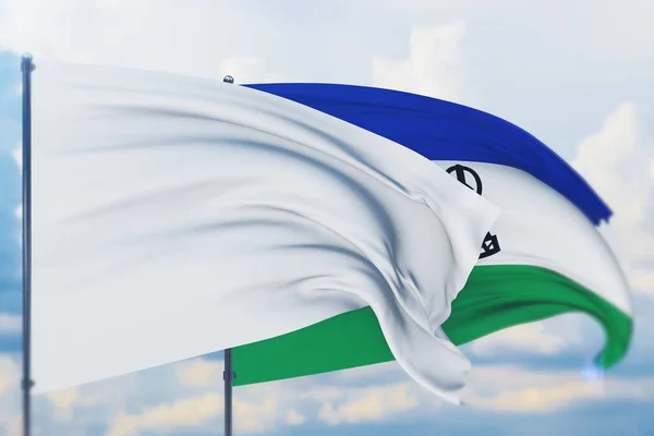 White flag on flagpole waving in the wind and flag of Lesotho. Closeup view, 3D illustration. — Stock Photo, Image