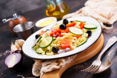 Makarna ve sebzeler plaka üzerinde lezzetli salata 