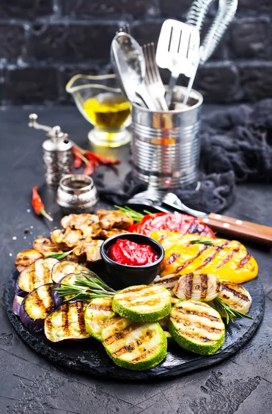 grilled vegetables with sauce on black board