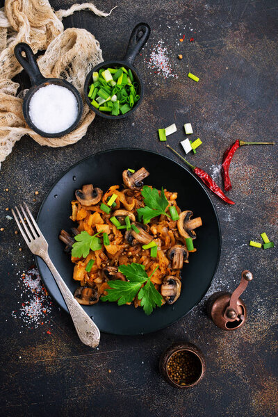  Vegan dish. Fried mushrooms and cabbage in the frying pan. European cuisine.