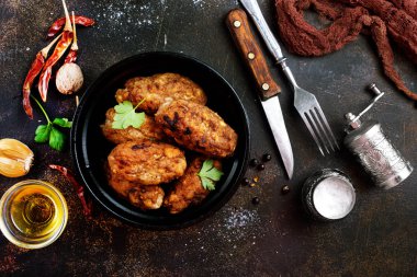 bir tabloda bir kapta kızarmış pirzola