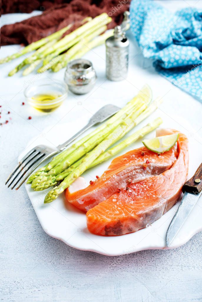 raw salmon and green asparagus on plate