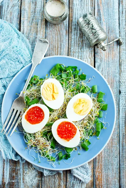 Eggs with red salmon caviar — Stock Photo, Image