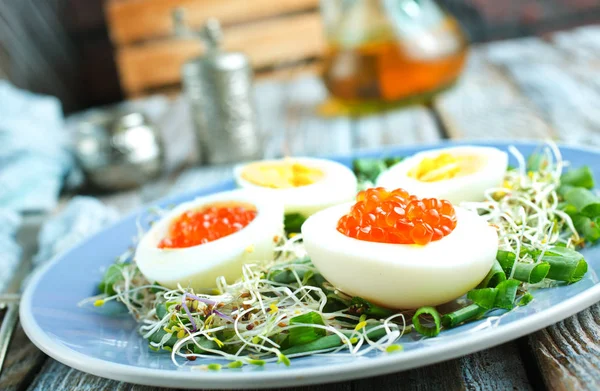 Eggs with red salmon caviar — Stock Photo, Image