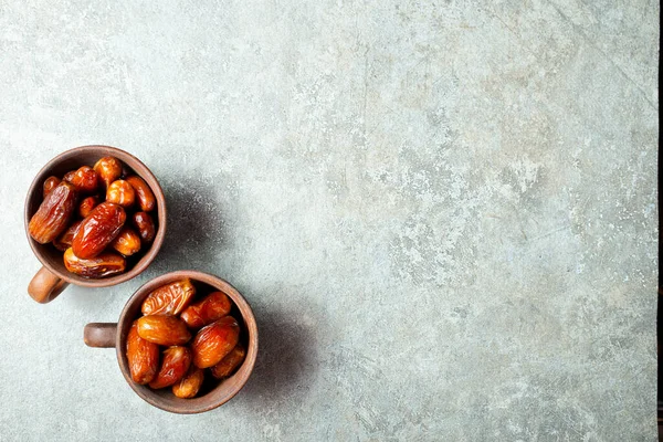 Dried Medjoul date fruit in bowls,  Delicious dried fruit