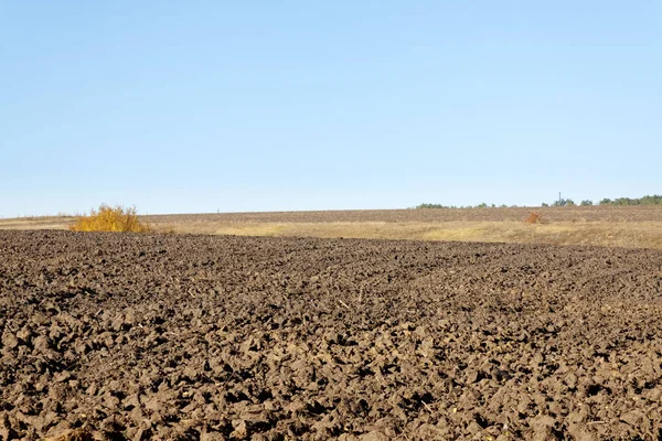 Plowed field on a bright sunny autumn day