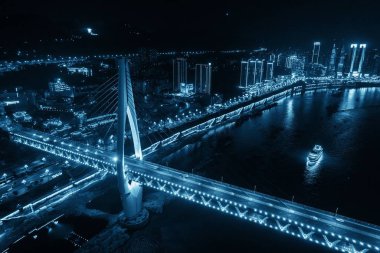 Aerial view of Bridge and city urban architecture at night in Chongqing, China clipart