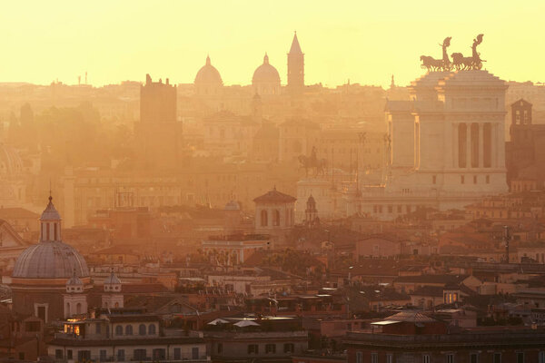 Rome rooftop view at sunrise with ancient architecture.