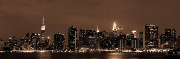 Midtown Manhattan skyline at dusk panorama over East River