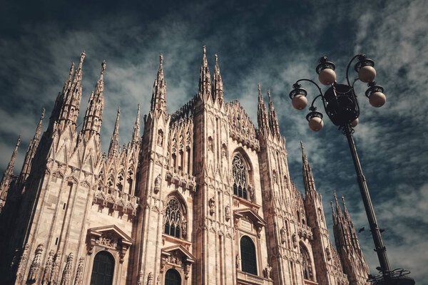 Duomo and lamp post at Cathedral Square or Piazza del Duomo in Italian, the center of Milan city in Italy. 