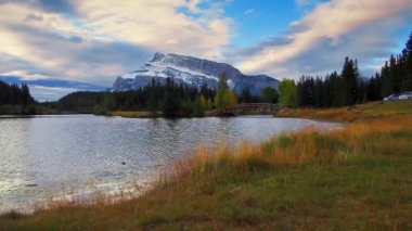 Banff Ulusal Parkı, Kanada'da ahşap köprü kar dağ ve sonbahar waterfront, yürümek.