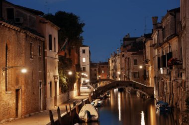 Venedik kanalı gece köprüsü ve tarihi binalarla birlikte. İtalya.