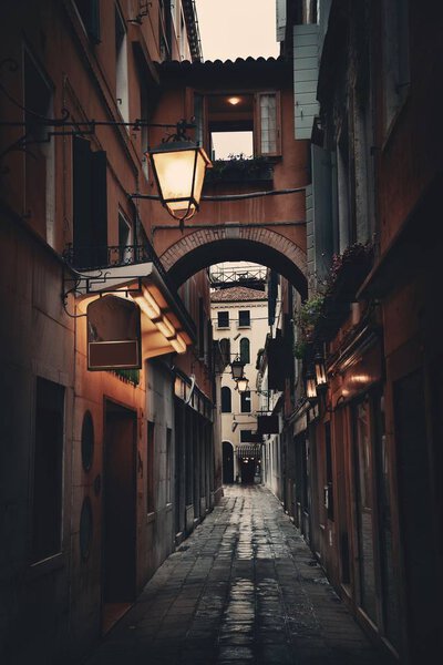 Alley view with historical buildings in Venice, Italy.
