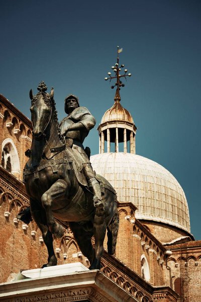 Statue and dome of old church in Venice, Italy.