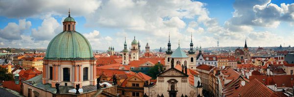 Prague skyline rooftop view with church and dome in Czech Republic panorama.