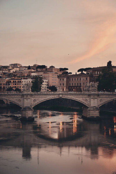 River Tiber and Rome ancient architecture with colorful sky at sunset, Italy.