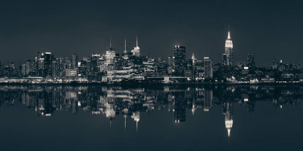 Midtown Manhattan skyline at dusk panorama over Hudson River with reflections