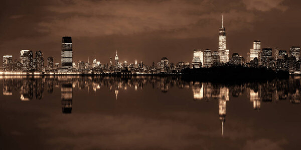 New York City at night panorama with urban architectures and reflections