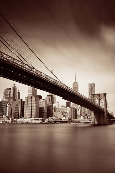 Below Brooklyn Bridge with downtown Manhattan skyline in New York City