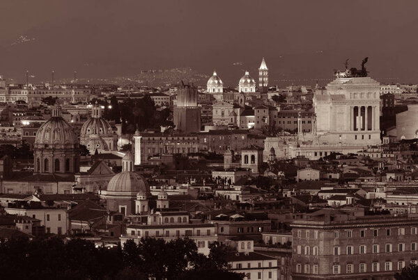 Rome rooftop view with ancient architecture in Italy at night in black and white.
