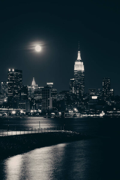 Moon rise over midtown Manhattan with city skyline at night