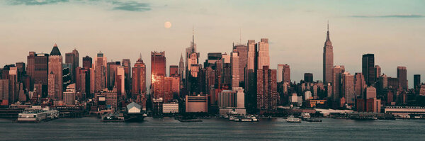 New York City skyscrapers urban view at sunset and moon rise.