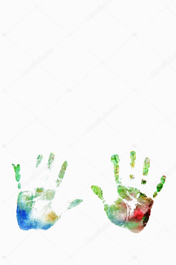 Close up of colored hand print of child on white background (happy childhood, art, fun, toy concept)