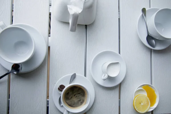 cup of black organic coffee and cups for tea as a symbol of coffee break and rest