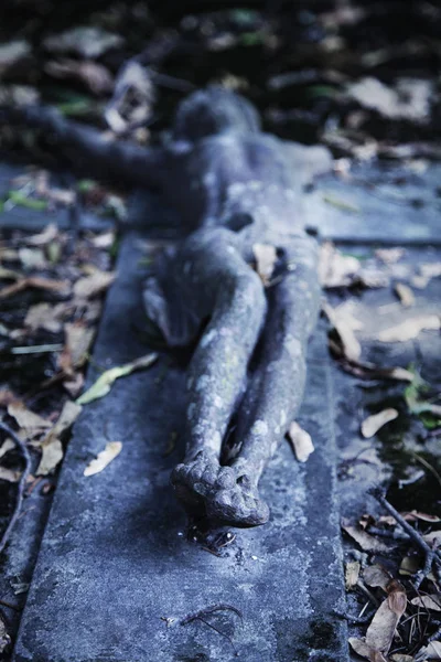 Suffering and death of Jesus Christ. View from the bottom of the ancient statue. The focus  on the feet of the crucified Christ. (Faith, religion, resurrection, immortality concept)