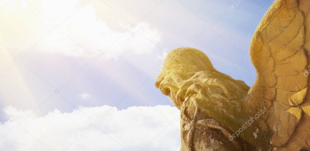 golden angel in the sunlight (antique statue)