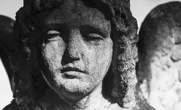 Angel of death as a symbol of the end of life. Fragment of ancient statue. (Religion, eternal life, immortality, faith concept)