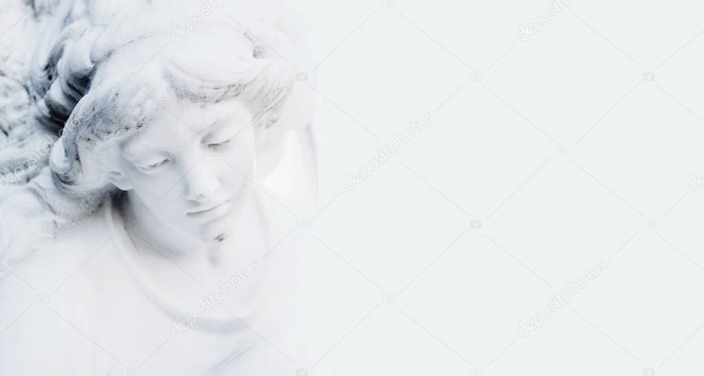 sad angel in the sunlight on white background (antique statue)