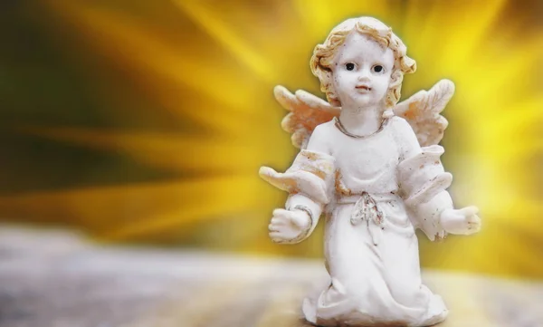 Ancient stone statue of  little angel as symbol of guard for children. Love, faith, hope, religion, Christianity, good concept.
