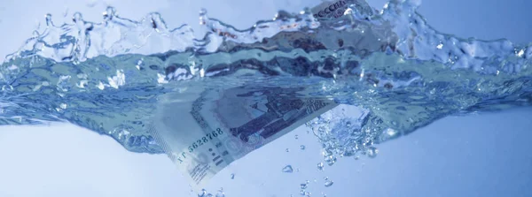 Pengar koncept. Rubler sjunker i vatten som symbol för financiall c — Stockfoto