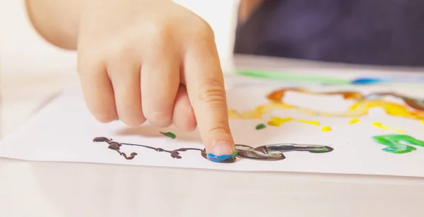 Child girl painting with colorful hands. Close up. — Stok fotoğraf