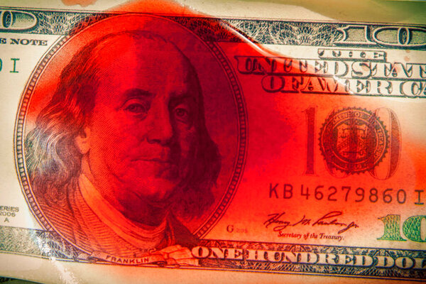 Close up bloody US Dollars as symbol of terrorism, death, suffering, loss and violence. Horizontal image.