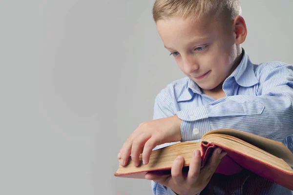 Little boy reading book as symbol of motivation to success and self development. Horizontal image.