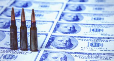 ABD Doları 'na karşı çıkarılan kurşunlar, iş dünyasının, askeri çatışmaların ve cinayetlerin soyut bir sembolü olarak tasarılıyor..