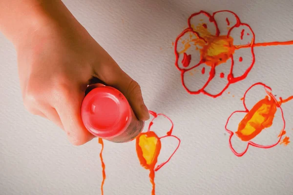 Children\'s art: happy cute little girl painting paints. Close uup, selective focus.