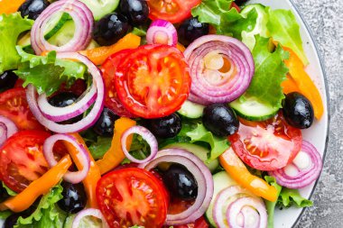 Yunan salatası. Domates, soğan, salatalık, biber, zeytin, marul ve beyaz peynir ile taze sebze salatası. Plaka üzerinde Yunan salatası