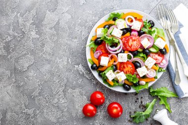 Yunan salatası. Domates, soğan, salatalık, biber, zeytin, marul ve beyaz peynir ile taze sebze salatası. Plaka üzerinde Yunan salatası