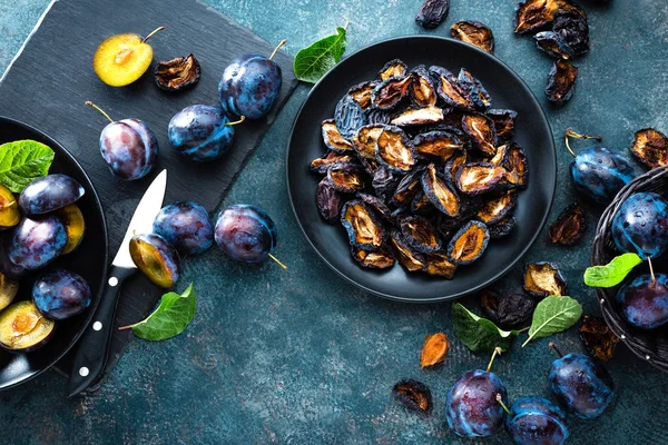 Dried prune and fresh plums with leaves